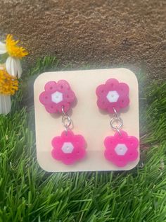 Two tiered pink Perler flower earrings. Perfect for summer☀️ nickel free Spring Pink Earrings With Handmade Flowers, Pink Earrings With Handmade Flowers For Spring, Pink Handmade Flower Earrings For Spring, Pink Flower Shaped Earrings For Summer, Pink Flower Earrings For Summer, Pink Flower-shaped Jewelry For Spring, Pink Flower Shaped Jewelry For Spring, Cute Summer Flower-shaped Earrings, Spring Pink Flower-shaped Jewelry