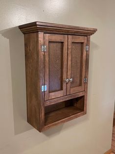 a wooden cabinet hanging on the wall