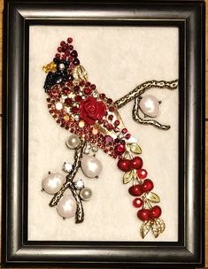 a framed picture with beads and flowers on it