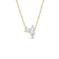 a gold necklace with two pear shaped diamonds