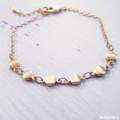 Beautiful dainty bracelet, this tiny coin bracelet is made with a dainty, yet durable, 18k gold plated coins and chain and it's perfect for layering with other chain bracelets or bangle bracelets (sold separately). ✤Small coin chain - 18K high-quality Gold plated Total length: 6//6.5//7//7.5//8 inches with an extension of 1.5 inches ✤If you need a different size please send me a message. Feel free to contact me for details & options. ♥All items are packed in an elegant jewelry box and ready Dainty Gold Plated Bracelet With Adjustable Chain, Dainty Gold Plated Charm Bracelet With Delicate Chain, Dainty Gold Plated Heart Bracelet, Adjustable Gold Plated Dainty Chain Bracelet, Dainty Adjustable Gold Chain Charm Bracelet, Minimalist Brass Chain Bracelet For Gift, Dainty Nickel-free 14k Gold-filled Bracelets, Minimalist Brass Chain Bracelet Gift, Dainty Gold Chain Charm Bracelet