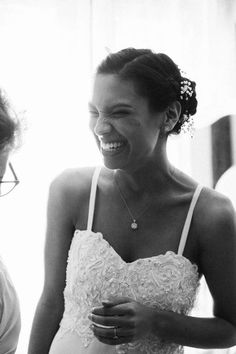 a woman laughing while standing next to another woman