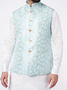 This sky blue cotton bundi jacket set will instantly give an elegant look. Made from cotton fabric, this 3 piece kurta set features a white kurta, sky blue bundi jacket, front buttons fastening, and a mandarin collar. This sky blue jacquard jacket has floral embroidery work all over. It is paired with white churidar. An ideal outfit for traditional occasions, and special events.

Size Chart For Men





	
	
					Men's Size Chart
		

		
		
						
				Size Chart For Men
				Custom Size Measurement Blue Cotton Nehru Jacket For Wedding, Blue Cotton Nehru Jacket For Festive Occasions, Festive Blue Cotton Nehru Jacket, Men Size Chart, Size Chart For Men, Sky Blue Outfit, White Churidar, Nehru Jacket For Men, White Kurta