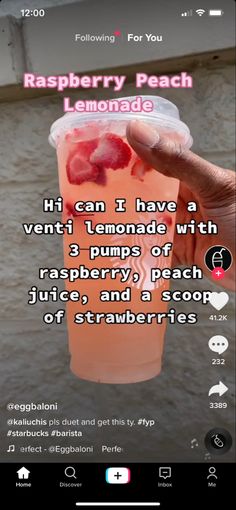 someone is holding up a plastic cup with strawberries in it and the caption reads raspberry peach lemonade