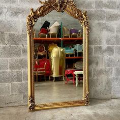 a large mirror sitting on top of a floor next to a shelf filled with shoes