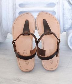 "SKOPELOS is named after a Greek island, and it's a T-strap sandal with a buckle closure lower than the ankle. A classic design, that many purchase year after year, in multiple colours. Wear it day or night, with any outfit, be it a pair of summer print pants, chinos, shorts, jeans, skirt, or dress. A true wardrobe staple, weather you are planning to visit a Greek island, or not! ALL ORDERS ARE SHIPPED VIA TNT EXPRESS WORLDWIDE (Please include a phone number at checkout, as it's required by the Brown Ankle Strap T-strap Sandals With Rubber Sole, Brown T-strap Sandals With Ankle Strap And Rubber Sole, Brown Toe Post T-strap Sandals For Vacation, Brown T-strap Sandals With Leather Sole For Summer, Brown Ankle Strap Sandals With Rubber Sole, Brown Leather Sole T-strap Sandals For Summer, Brown T-strap Sandals With Single Toe Strap For Vacation, Brown T-strap Sandals With Single Toe Strap For Summer, Brown T-strap Sandals With Leather Sole