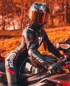 a person wearing a helmet sitting on a motorcycle