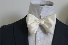 Handsome&Lace Self-Tie Bow Ties: I handmade this oversized retro style bow tie from a soft and butter ivory satin.  This bowtie is s perfect for your special day and will turn heads.   * If you prefer standard size bowties as opposed to the oversized style, select standard option when checking out. : )Best part about my bowties are that are Self Tying but you don't have to tie it every time because they come on and off at the back so you can attach and adjust in the same pull.Multiples of 5 Dapper White Suit And Standard Tie Accessories, Dapper White Tie For Black Tie Events, White Bow Suit And Tie Accessories As Gift, Elegant White Suit And Tie Accessories For Party, White Bow Tie Suit Accessories For Gift, Classic White Bow For Black Tie Occasions, Dapper White Ties For Black Tie Events, White Suit And Tie Accessories With Bow For Gifts, White Suit And Tie Accessories With Bow As Gift