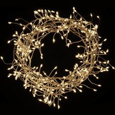 a lighted wreath with white lights in the shape of branches on a black background photo