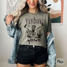 The perfect T that is a blend of spooky and sassy with our 'Yeehaw Witches' Halloween shirt! This Comfort Colors tee brings retro cowgirl witch vibes, perfect for women who love vintage style with a Halloween twist. Whether you're heading to a Halloween bash or just showing off your witchy vibes, this soft, durable t-shirt makes a great gift for her. Designed for comfort and style, it's the ideal choice for the season. The Comfort Colors 1717 is the ultimate garment-dyed t-shirt, made 100% with Witchy Cotton Short Sleeve Tops, Witchy Short Sleeve Cotton Tops, Witchy Crew Neck Halloween Tops, Witchy Crew Neck Top For Halloween, Witchy Cotton Tops With Letter Print, Cotton Horror T-shirt For Fall, Witchy Graphic Print Crew Neck Tops, Witchy Cotton Crew Neck Tops, Witchy Letter Print T-shirt For Fall