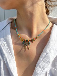 *This bohemian dream catcher with feathers necklace made with a brass pendants and colorful different sizes beads. It is a perfect fit for boho, hippie style and a great gift for spirituality lovers.  *This beaded necklace is made with bohemian gold charms, beautiful colorful beads and gold spacers.  *It has a lobster clasp closure and an extension chain allowing for easy adjustability and remove.  *It is ready to ship immediately. *Necklace Length: 16 inch (with 1 inch extender to make the neck Bohemian Beaded Charm Necklaces For Beach, Bohemian Gold Turquoise Necklace With Colorful Beads, Bohemian Gold Turquoise Necklace For Beach, Bohemian Turquoise Necklace For Beach, Bohemian Turquoise Necklaces With Tiny Beads, Bohemian Gold Charm Necklaces With Dangling Beads, Bohemian Tiny Beads Turquoise Necklace For Beach, Bohemian Charm Necklaces With Dangling Beads For Gifts, Bohemian Charm Necklaces With Dangling Beads As Gift