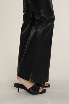 Embrace your edgy style with our Faux Leather Flare Pants. A chic choice that effortlessly transitions from day to night, pair these pants with a casual tee, an elegant blouse, or complete the ensemble with the matching double-breasted leather blazer. Built for comfort, these leather flared pants feature an elastic waistband for easy wear and side slits that allow you to show off your equally chic footwear. Faux leather Flared cut Side slits Elastic waistband Comes in Beige, Army, Mahogany, and Trendy High-waisted Leather Pants For Spring, Edgy Faux Leather Straight Pants, Edgy Spring Pants, Chic Wide-leg Leather Pants For Workwear, Edgy Leather Straight Pants For Work, Trendy Spring Straight Leg Leather Pants, Edgy Straight Leather Pants For Work, Fashion-forward High-waisted Pants, Trendy Leather Bottoms For Spring