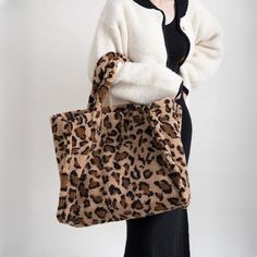 Unleash Your Style with Our Leopard Print Tote Step into the world of fashion with our stunning Faux Fur Tote Bag, a must-have accessory that combines style and versatility. Perfect for the fashion-forward woman, this bag is your ideal companion for any occasion, whether you're shopping, meeting friends, or just out for a casual stroll. Exceptional Design and Quality Crafted from high-quality faux fur, our tote bag boasts a bold leopard pattern that makes a statement. The bag's spacious interior Fur Tote Bag, Leopard Print Tote, Faux Fur Material, Cardigan Sweater Vest, Meeting Friends, Meet Friends, Casual Tote, Leopard Pattern, Print Tote