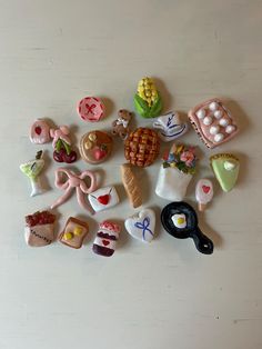 a collection of miniature food items sitting on top of a white table next to each other