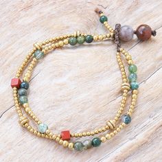 Pretty agate gems in varying shades of green mingle with shimmering brass on Tiraphan Hasub's pretty bracelet. The Thai artisan hand crafts the double-stranded bracelet from smooth brass beads red jasper cubes and green agate gems. She then finishes her creation with a button clasp fashioned from large agate beads and waxed polyester cord. Czech Glass Bead Bracelet, Blessing Beads, Jasper Bead Bracelet, Hand Crafts, Brass Beads, Jewelry Making Necklace, Small Beads, Wrap Bracelets, Pretty Bracelets