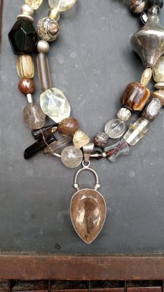 Walk that walk like the  fashionista you are..a fun neutral piece to compliment any outfit.  A large quartz pendant is surrounded by various sizes and shapes of quartz beads. Agate, jasper and crazy horse are also added.  Be individual..make a statement! Measures 18 inches. Hook closure. #yourjewelryshouldmakeyousmile Item # 370 Gem Stone Necklace, Large Bead Necklace, Art Statement, Art Necklace, Diy Jewelry Necklace, Neutral Boho, Art Necklaces, Bracelet Display, Chunky Jewelry