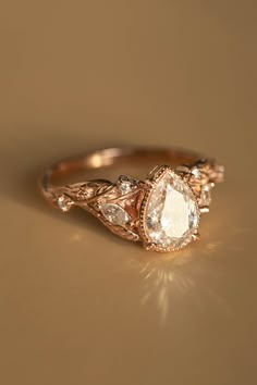 an engagement ring with three pear shaped diamonds