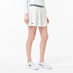 This tennis skirt, tried and tested by Lacoste players, features wide, elegant pleats, stretch fabric for freedom of movement, and Ultra Dry moisture-wicking technology. A blend of Lacoste style and technical prowess. Sporty Stretch Tennis Skirt With Pleated Hem, Tennis Skirt With Pleated Hem, White Pleated Skirt In Athleisure Style, Sporty Stretch Tennis Skirt With Pleated Waist, Sporty Fitted Tennis Skirt With Pleated Waist, Stretch Tennis Dress With Pleated Skirt, Athleisure Pleated Tennis Dress, Sporty Relaxed Fit Lined Pleated Skirt, Lined Tennis Skirt