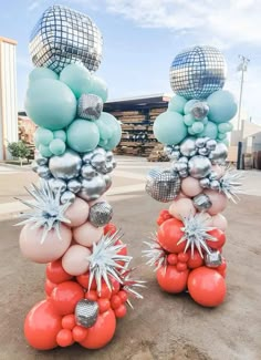 two large balloons with silver and blue decorations