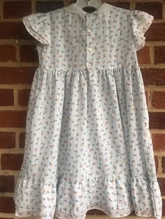 "Smoke free home/good vintage condition, no issues/pit to pit 12\"/length 24\"/(120)" Summer Cotton Smocked Dress With Flutter Sleeves, Cotton A-line Dress With Ruffles, Cotton Smocked Dress With Flutter Sleeves And Ruffles, Flutter Sleeve Dress With Smocked Bodice For Garden Party, Casual Cotton Sundress With Smocked Back, Cotton Sundress With Smocked Back For Casual Occasions, Cotton Sundress With Smocked Back For Casual Wear, Spring Fitted Smocked Dress With Ditsy Floral Print, Cute Fitted Vintage Dress With Ruffles