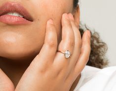 a close up of a person wearing a ring with a diamond on the middle of their finger