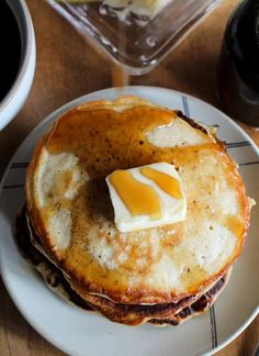 a stack of pancakes with butter and syrup on top