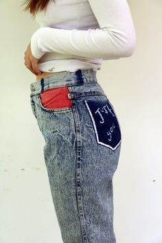 "Vintage acid wash jeans a lot of love left in these jeans, high waist tapered legs, pockets in colors - red blue, and yellow, embroidered back pocket (looks like hand embroidered by the previous owner ) the belt loops were removed -Looks appropriate with the overall look of the jeans, zipper Ankle, brand TOPPER - vintage Israeli brand. aside from minor signs of wear, good vintage condition, clean ready to wear. *Model is 5'7\" and a size small for reference** Approximate size: S -  Please refer High Waist Red Denim Jeans, Red Retro Denim Bottoms, Red Denim Bottoms With Five Pockets, 90s Inspired Medium Wash Cotton Jeans, Red High Rise Jeans With Five Pockets, Retro High Waist Red Jeans, Red Relaxed Fit Denim Jeans, Red Denim Jeans With Relaxed Fit, Red High-rise Jeans