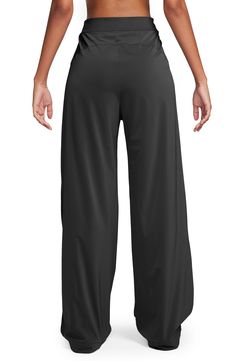 Crisp pleats play up the wide-leg silhouette of these comfortable, casual pants embellished with a signature Swoosh logo. 31" inseam; 24 1/2" leg opening; 14 1/2" front rise; 17 1/2" back rise (size XX-Large) Zip fly with hook-and-bar closure Front slant pockets 81% nylon, 19% spandex Machine wash, tumble dry Imported Nike Relaxed Wide Leg Bottoms, Nike Relaxed Fit Solid Color Bottoms, Nike Relaxed Fit Solid Pants, Nike Casual Wide Leg Bottoms, Nike Relaxed Fit Full Length Bottoms, Nike Wide Leg Loungewear Pants, Spring Nike Pants, Black Full Length Wide Leg Pants With Pull-on Style, Nike Bottoms With Elastic Waistband