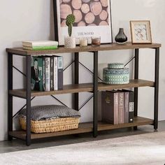 a book shelf with books and other items on top of it in a living room