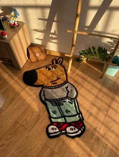 a cartoon bear rug on the floor in a child's room with wooden floors