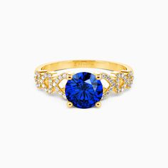 a yellow gold ring with blue sapphire and diamonds