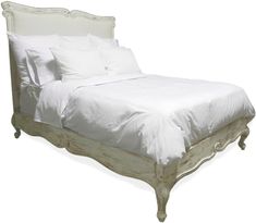 a bed with white linens and pillows on it's headboard, in front of a white background