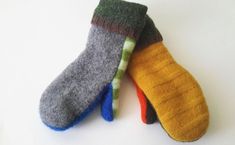 three pairs of socks with different colors on them sitting next to each other in front of a white background