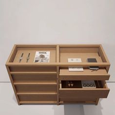 a wooden desk with many drawers and items on it's sides, including an electronic device