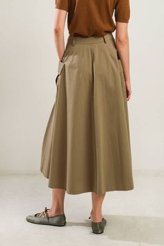 A solid woven full skirt featuring front closure and side pockets Details: Self : 100% Cotton Size & Fit - Model is 5`8" And Wearing Size Small- Measurements Taken From Size Small- Approx. Length: 33.5" Khaki Flared Lined Skirt, High Waist Solid Skirt With Pockets, Chic Midi Cargo Skirt With Pockets, Khaki Long Pleated Skirt, Chic Cargo Midi Skirt With Pockets, Khaki Pleated Midi Skirt, Casual A-line Skirt With Pockets, Khaki Midi Skirt With Pockets, High Waist Brown Skirt With Pockets