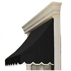 an awning on the side of a building with black and white trimmings