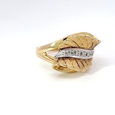 This Diamond and 14k Yellow Gold Retro Leaf Ring is the perfect way to add a touch of vintage flair to any ensemble. Crafted with a combination of 14k yellow gold and diamonds, this ring is sure to become a treasured piece of jewelry for many years to come. Jewelry Style : RingMetal Type : 14K Yellow GoldDiamonds : 6 round, single cutDiamond Weight : Approximately .040 ctwColor : H-IClarity : VS Size 6.5Stamped "14k 7G 302"Approximate Weight : 6.22 gramsRing Size : 6.75 Diamond Leaf Ring, Retro Ring, Jewelry Style, Leaf Ring, Modern Jewelry, Estate Jewelry, Free Shopping, Diamond Rings, Jewelry Shop