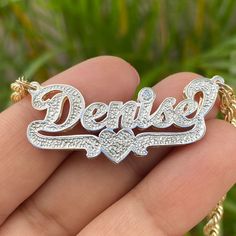 Make a statement with this personalized cursive double name plate pendant! Give your jewelry box an upgrade with this classy, diamond cut beauty - featuring your name and an adorable heart underline with an added genuine diamond accent! So sweet it'll give you heart eyes! The genuine diamond is set above the dot of a lowercase "i" or "j". If your name does not have an "i" or "j", we can set the diamond in the center of the heart. Choose from 10k or 14k yellow, rose, or white gold. Metal: 10k or Engraved Custom Nameplate Necklace For Anniversary, Personalized White Gold Nameplate Necklace, Anniversary White Gold Nameplate Necklace, Custom Name White Gold Nameplate Jewelry, Anniversary Nameplate Name Necklace With Hallmarks, White Gold Nameplate Jewelry With Names, Custom Nameplate Necklace For Anniversary, Custom Name Nameplate Jewelry For Anniversary Gift, White Gold Nameplate Necklace