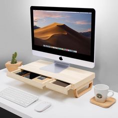 an apple computer sitting on top of a desk