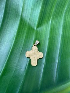 a cross on a green leaf is shown