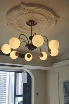 a chandelier hanging from the ceiling in a living room