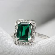 Handmade by an inspired jewelry artist team with decades of experience in the craft of jewelry making.Each gemstone, each diamond is carefully picked.Using only the finest raw materials and the highest industry standard in manufacturing, design and finish.A Stunning Emerald and diamonds ring, handmade to order in any size.Flaunting a prong set 8 x 6 mm, octagon cut Green chatham emerald.The stone is set a little high on the finger maximizing its presence and appeal. Ring features:............... Timeless Green Rings With Accent Stones, Timeless Cubic Zirconia Emerald Promise Ring, Timeless Cubic Zirconia Emerald Ring For Anniversary, Crystal Ring With Diamond Center Stone For May Birthstone, Timeless Green Diamond Ring Gift, Classic Emerald Ring For Promise, Classic Emerald Ring With Halo Design, Promise Emerald Cut May Birthstone Ring, May Birthstone Crystal Ring With Diamond Center Stone