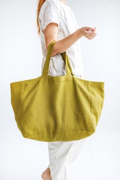 "This large linen bag is perfect for a long-awaited summer holiday, picnic, or trip to the beach. Made of soft heavyweight linen that feels lovely to the touch. Roomy enough for large towels along with other essentials. The bag has an extra linen lining, so it can easily withstand heavier items. * Which is your favorite color? Olive / Ocean / Terracotta. Beach bag approx. size: Height: 35 cm / 14\" Length: 45 cm / 18\" Width: 22 cm / 9\" Handles: 26 cm / 10\" (Strap drop length) \"Custom size av Beach Canvas Tote Bag With Pockets, Large Capacity Linen Canvas Bag For Travel, Rectangular Beach Canvas Bag With Pockets, Summer Linen Canvas Bag For Travel, Summer Linen Canvas Travel Bag, Summer Beach Linen Canvas Bag, Khaki Tote Beach Bag, Eco-friendly Linen Shoulder Bag For Beach, Linen Tote Canvas Bag For Beach