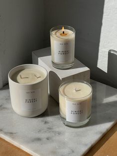 three candles sitting on top of a counter