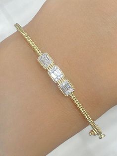 100% Genuine Natural 0.25 CTW Diamond / Baguette Bangle Bracelet in 14 KT    ITEM CONDITION : BRAND NEW . DIAMOND CARAT : 0.25 CTW DIAMOND CUT : ROUND BRILLIANT CUT. DIAMOND COLOR : G-H DIAMOND CLARITY : SI DIAMOND SYMMETRY : EXCELLENT DIAMOND SETTING : PRONG SETTING ITEM NO : 87771 GOLD CARAT : 14 KT  SUGGESTED RETAIL VALUE : $2025.00 Match it with an equally beautiful Chain, Charm & Earring – Available in our Store! ALL ITEMS ARE BRAND NEW! Our Diamonds are 100% Natural and are neither Treated Fine Jewelry Baguette Diamond Bangle Bracelet, Baguette Diamond Bracelet Fine Jewelry, Anniversary Baguette Diamond Bracelet, Baguette Diamond Bracelet In Yellow Gold, Baguette Cubic Zirconia Bracelets In Fine Jewelry Style, Baguette Cubic Zirconia Bracelet Fine Jewelry, 14k Gold Diamond Bracelet With Baguette Diamonds For Anniversary, 14k Gold Diamond Bracelet With Baguette Diamonds, Fine Jewelry 14k Gold Diamond Bracelet With Baguette Diamonds