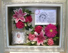 a framed photo with flowers and a baby's name on it in a silver frame