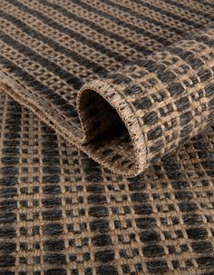 a close up view of the textured fabric in brown and black tones, with an interesting pattern