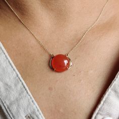 "ITEM DESCRIPTION: >>The pendant is made from Solid 14K Yellow Gold. Gemstone used is absolutely natural and ethically sourced. >>Natural Red Onyx in cabochon cut and round shape with a prong setting is studded on it with utmost precision. >>This is a minimalist design and is absolutely hassle-free and everyday jewelry. Gem: Red Onyx Gem size: 14x14 mm Gem weight: 8.44 carats Gold purity: 14K (58.33% approx.) Gold weight: 1.45 grams Gross weight: 3.14 grams These pendant comes with 16\" inches a Ruby Cabochon Round Jewelry, Elegant Carnelian Necklaces In Yellow Gold, Elegant Yellow Gold Carnelian Necklace, Red Gemstone Pendant Necklace, Yellow Gold Pendant Jewelry With Large Stone, Red Gemstone Pendant Necklaces, Fine Jewelry Round Cabochon Necklaces, Red 14k Gold Jewelry With Polished Finish, Red 14k Gold Polished Jewelry