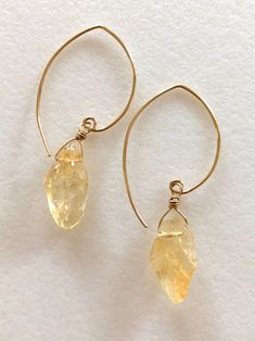 "Lovely honey amber yellow citrine nuggets wire wrapped in 14k gold fill on handmade matching gold fill ear wires. Rough nuggets are approximately 12 x 15mm and matched as closely as possible for natural gemstones. Total drop is 2\". Also in Sterling silver." 14k Gold-filled Yellow Gold Earrings With Natural Stones, Gold Hand Wrapped Teardrop Earrings, Yellow Citrine Teardrop Jewelry, Teardrop Citrine Yellow Jewelry, Gold Citrine Gemstone Earrings, Delicate Gold Citrine Jewelry, Gold Hand-wrapped Dangle Jewelry, Gold Hand Wrapped Dangle Jewelry, Amber Citrine Drop Earrings