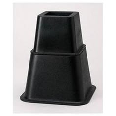 a black vase sitting on top of a white table